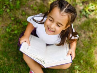 Girl joyful reading an inspirational book.