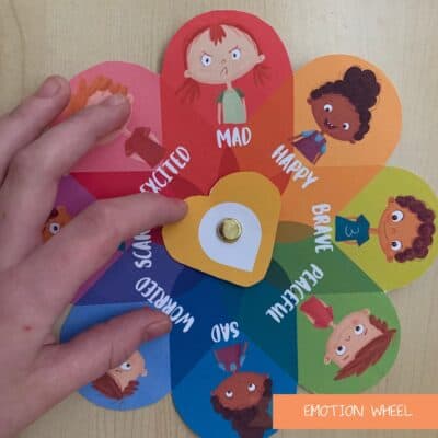 Feelings wheel for kids with a child's hand spinning the arrow.