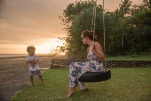 Mom and child playing on a tire swing