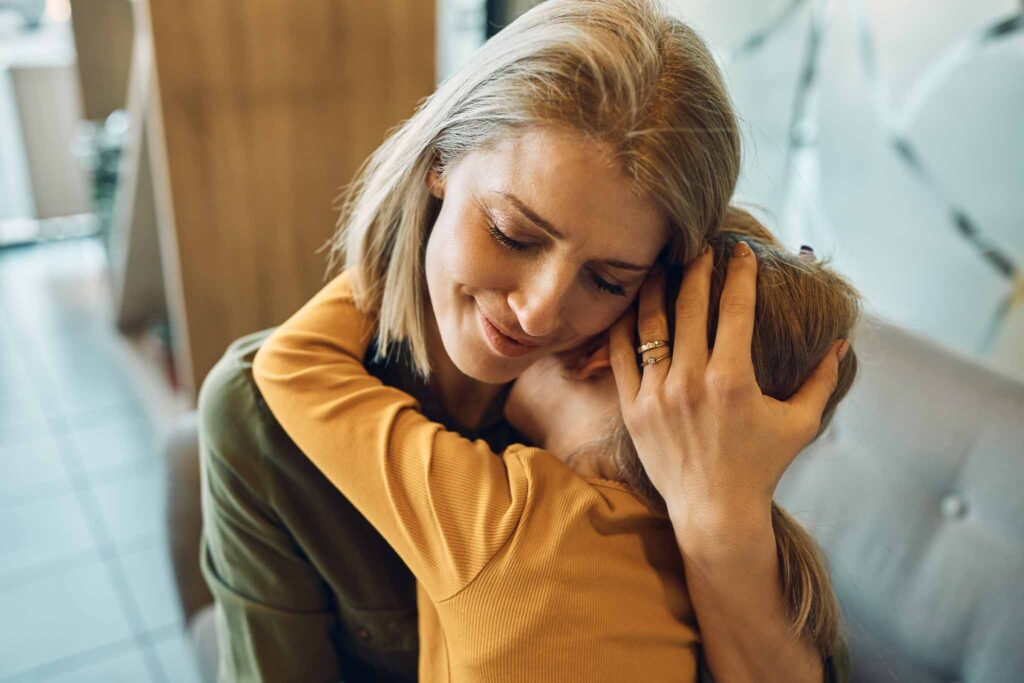 mom hugging and comforting daughter. 